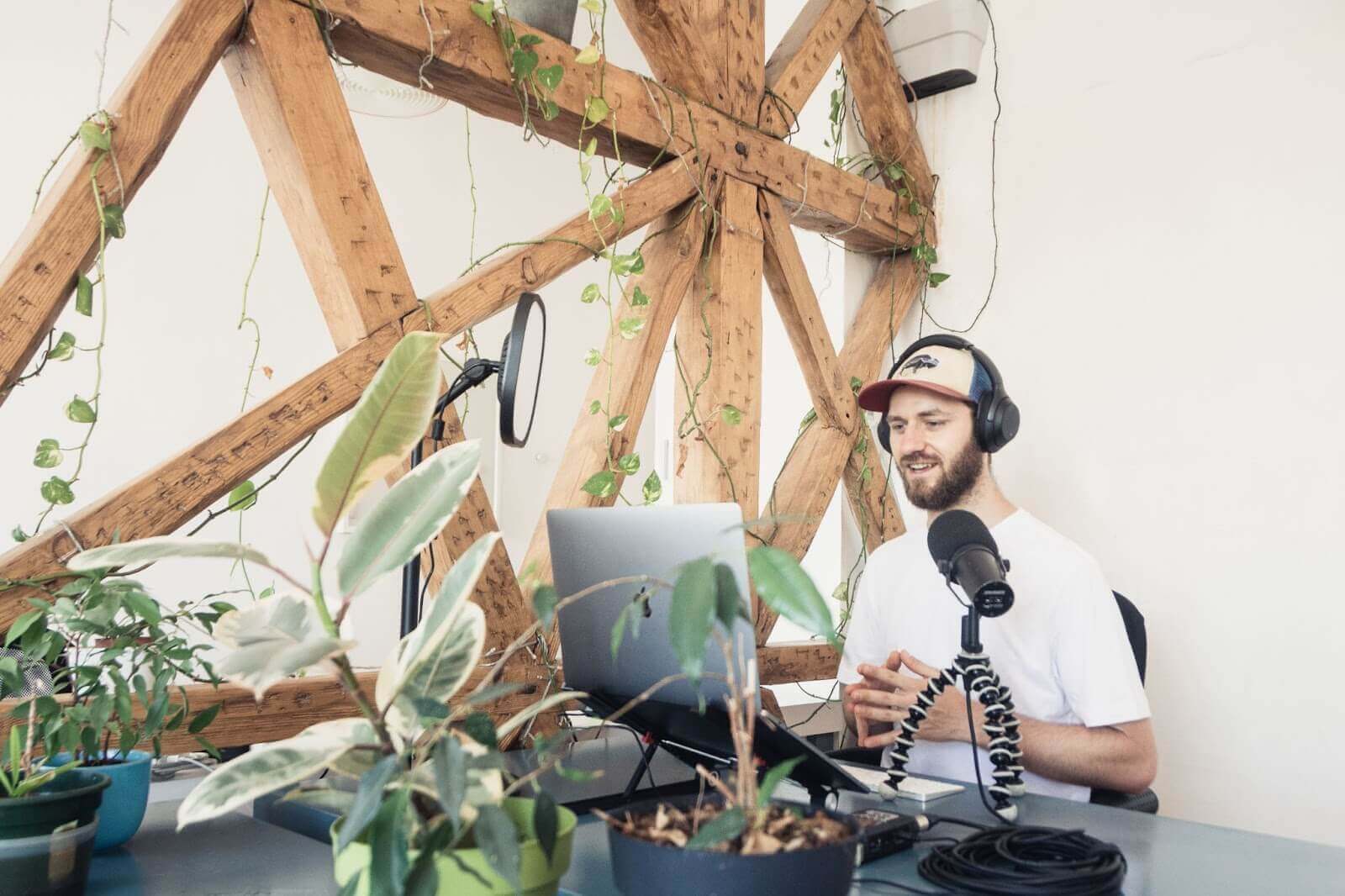 Image of guy in hat recording a podcast remotely