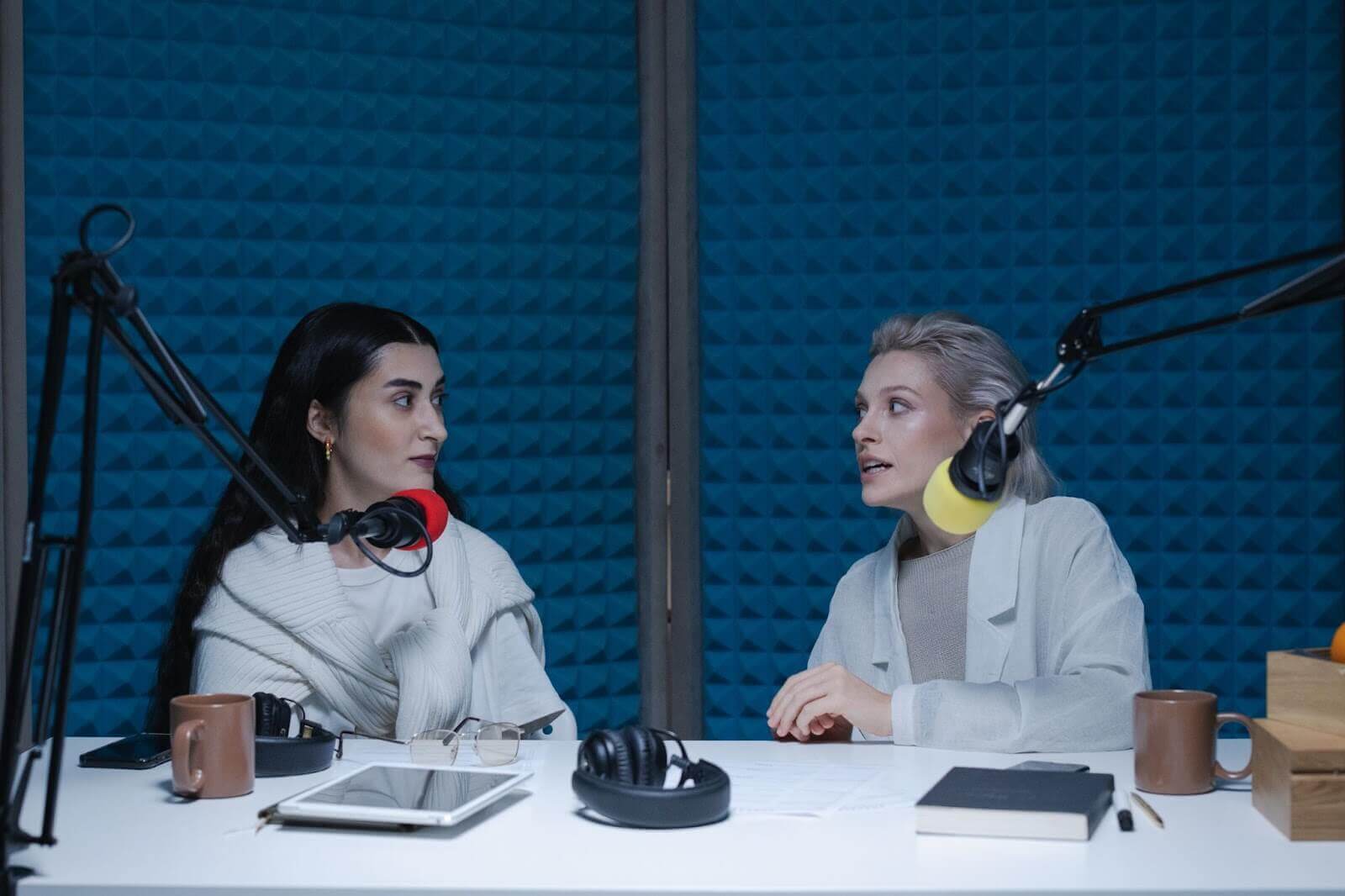 Two women having conversation in sound treated studio.