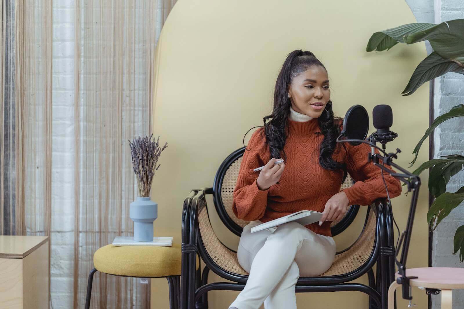 Woman recording podcast in home studio.